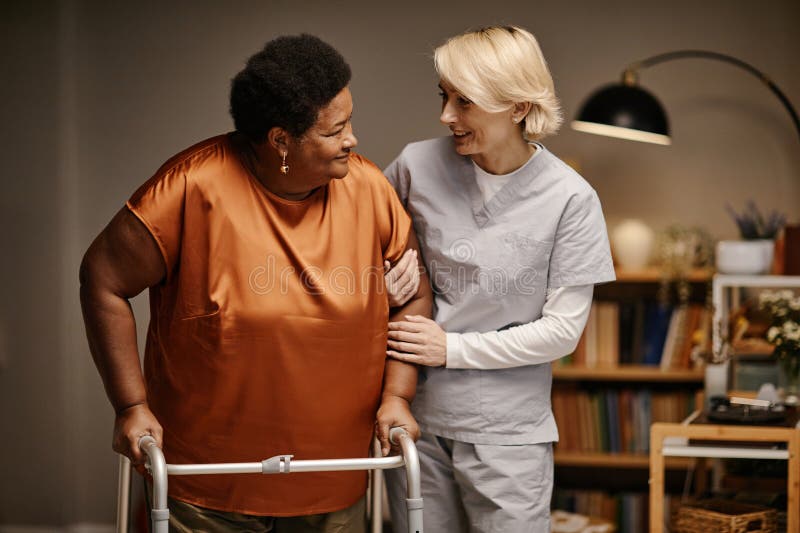 Caregiver supporting senior with walker
