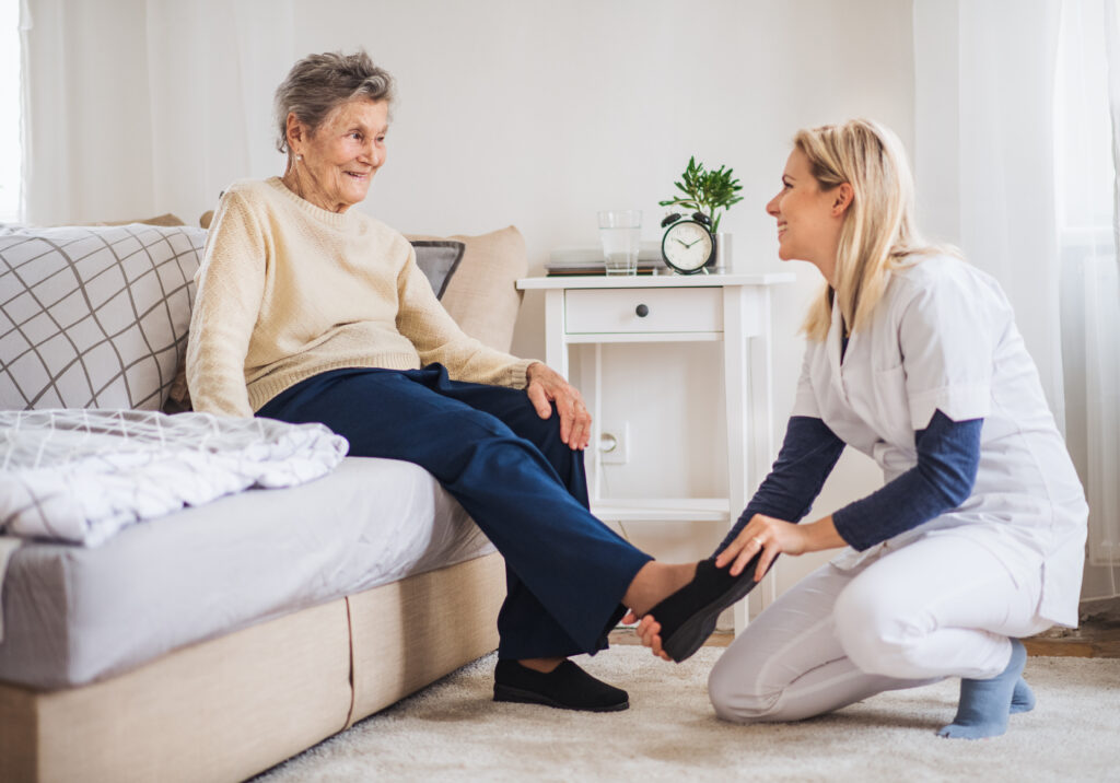 Caregiver helping senior woman