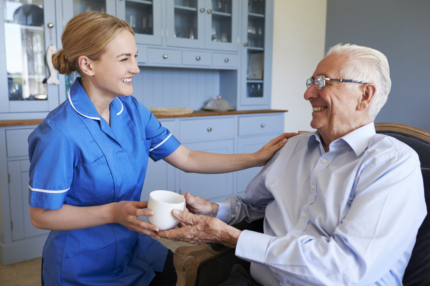 Caregiver with senior man at home